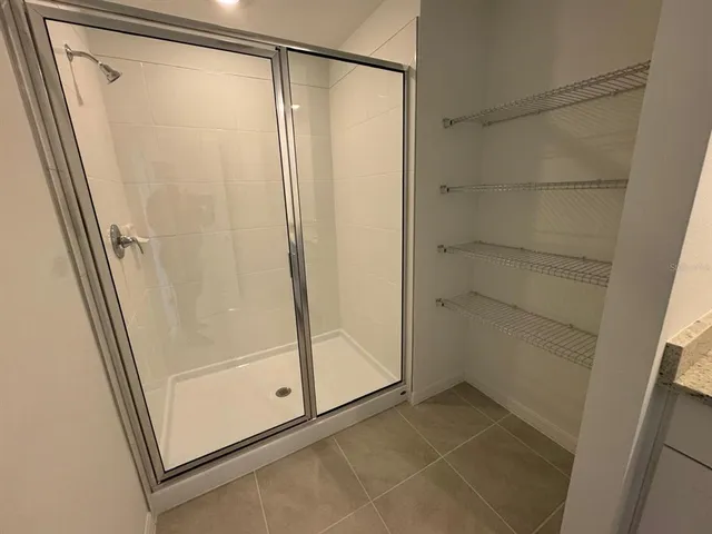 a bathroom with a glass shower door