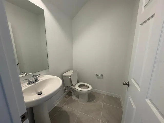 a white toilet sitting next to a bathroom sink