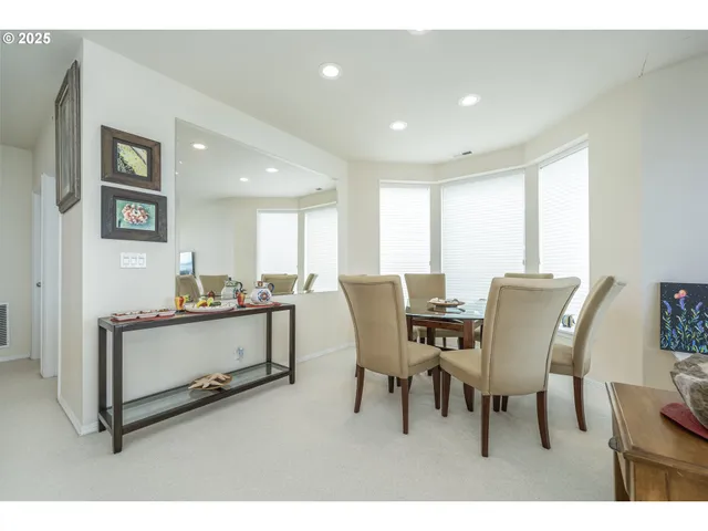 a bedroom with furniture and a large window