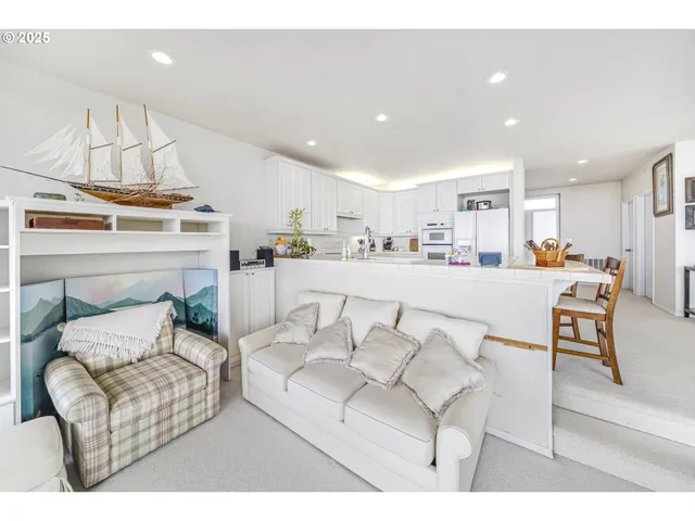 a living room with furniture a flat screen tv and a table