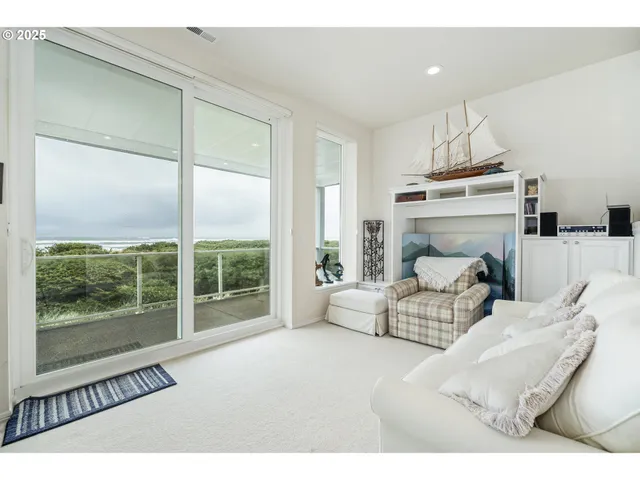a kitchen with stainless steel appliances kitchen island granite countertop a table chairs and a refrigerator