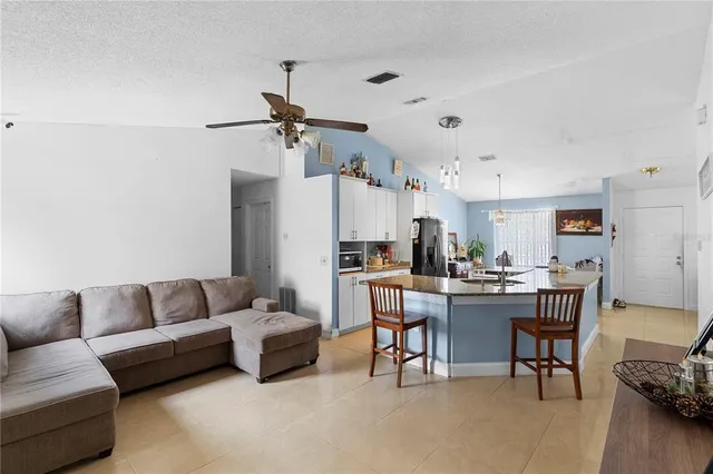 a living room with furniture and a dining table