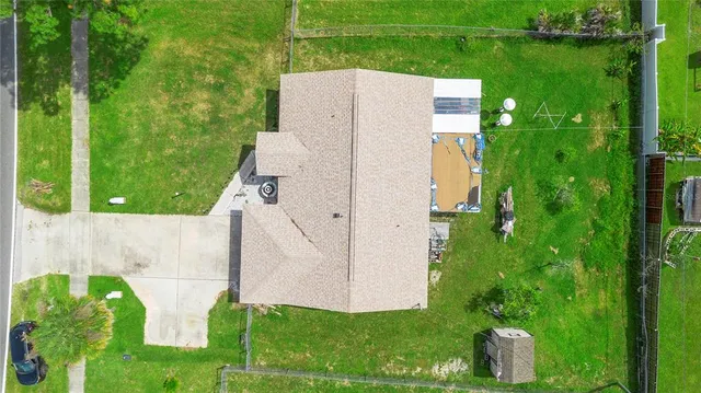 an aerial view of a house with a yard