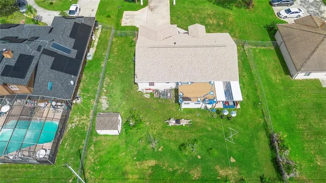 an aerial view of residential house with an outdoor space and seating