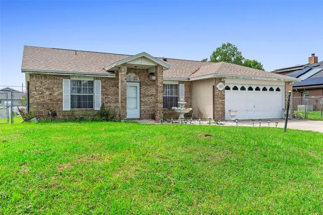 a view of a house with brick walls and a yard with a small yard