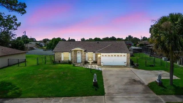 a view of a yard with a house in the background