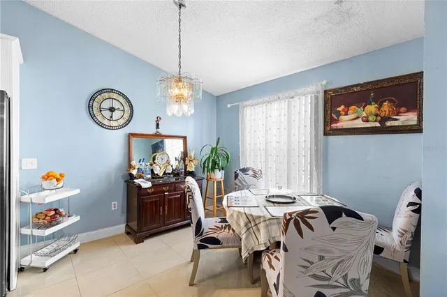 a dining room with a bed and a chandelier