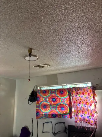 a view of a room with wooden floor and windows