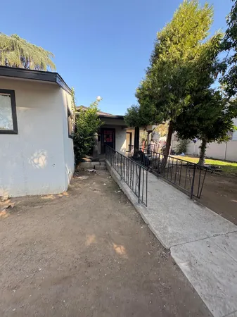 a view of a house with wooden fence