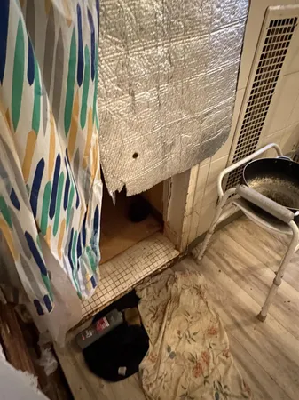 a room with a chair and appliances