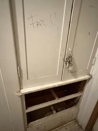 a white toilet sitting next to a white sink
