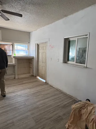 a kitchen with stainless steel appliances granite countertop a sink and wooden floor