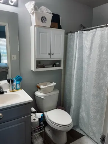 a bathroom with a toilet a sink and a mirror