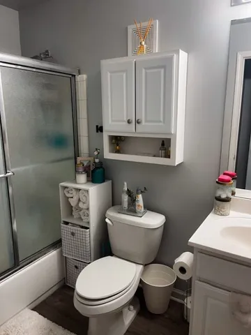 a bathroom with a toilet a sink and a shower