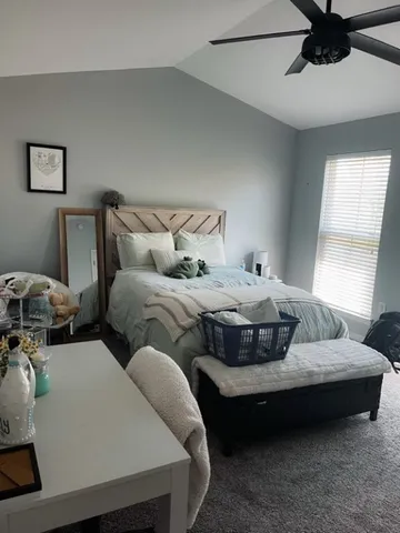 a bedroom with bed and window