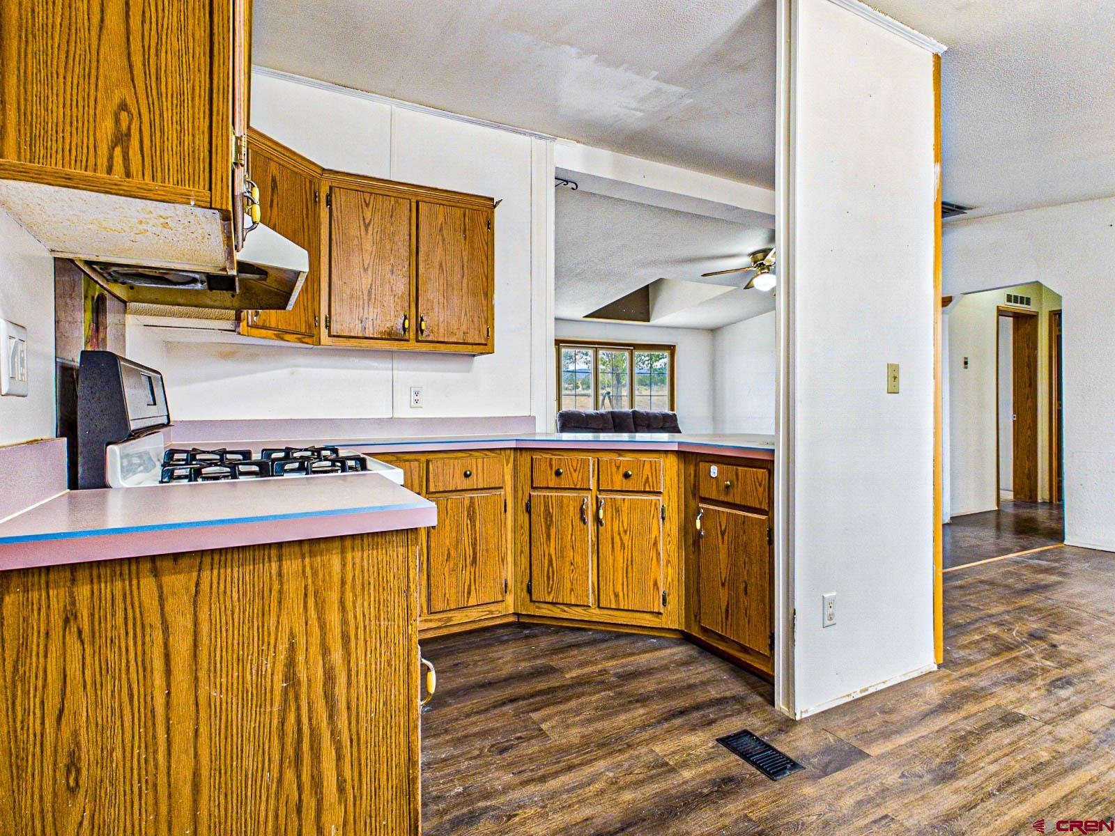 15484 Peach Road Cedaredge, CO 81413 - Photo 11 of 35 a view of a kitchen with stainless steel appliances granite countertop a refrigerator and a stove
