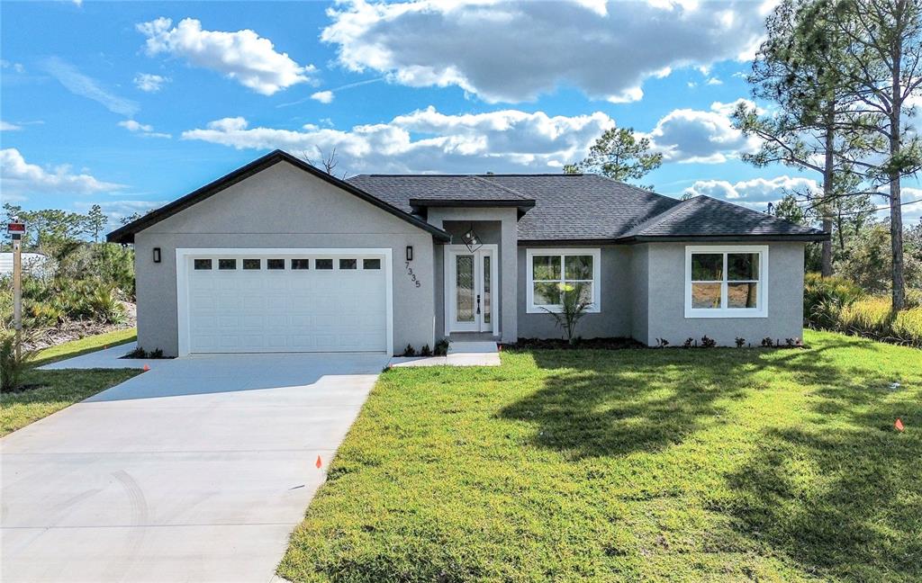 7335 Domenico Street Sebring, FL 33872 - Photo 1 of 38 a front view of a house with garden