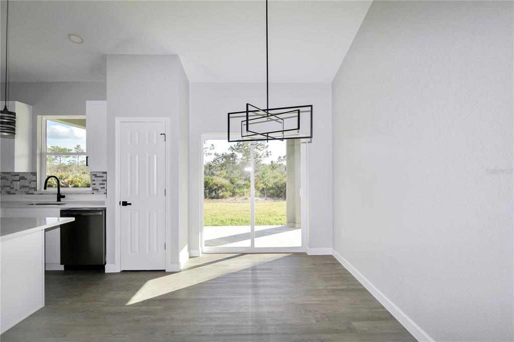 7335 Domenico Street Sebring, FL 33872 - Photo 11 of 38 a view of a kitchen with a sink dishwasher and wooden floor