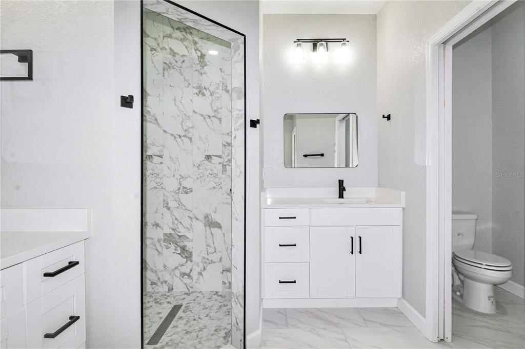 7335 Domenico Street Sebring, FL 33872 - Photo 19 of 38 a bathroom with a sink a toilet and shower