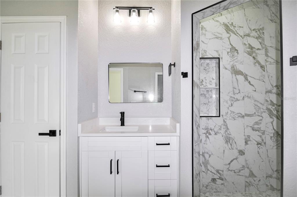 7335 Domenico Street Sebring, FL 33872 - Photo 21 of 38 a bathroom with a sink and a mirror