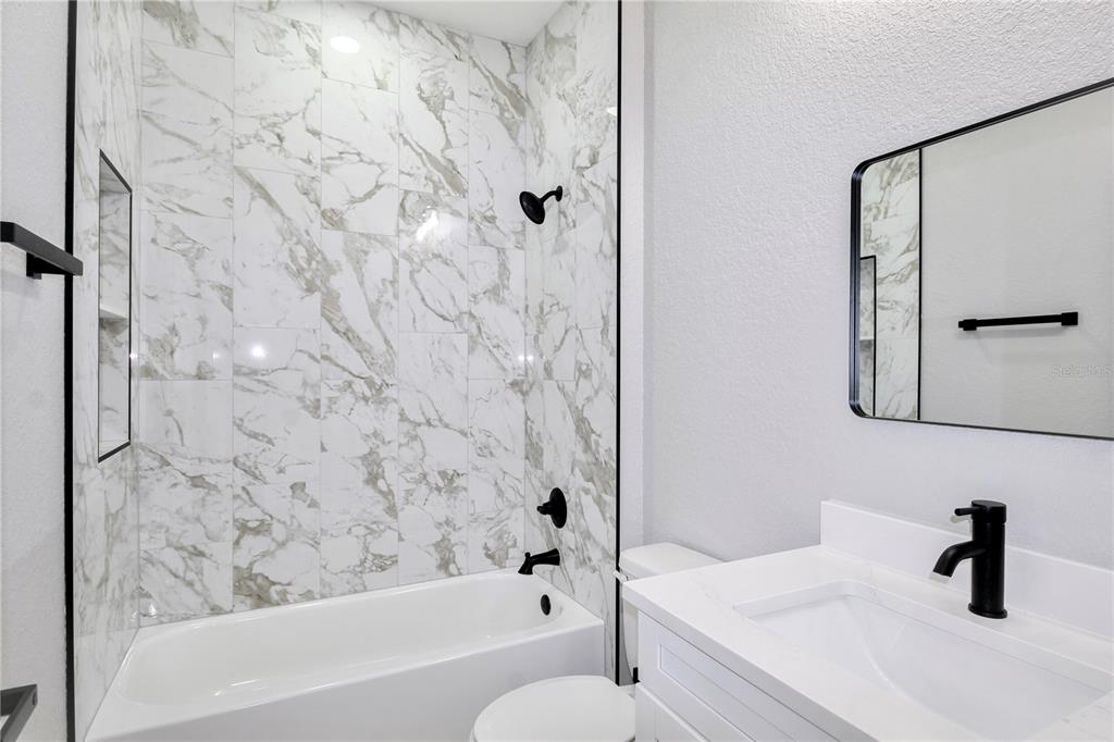 7335 Domenico Street Sebring, FL 33872 - Photo 29 of 38 a bathroom with a tub sink and vanity