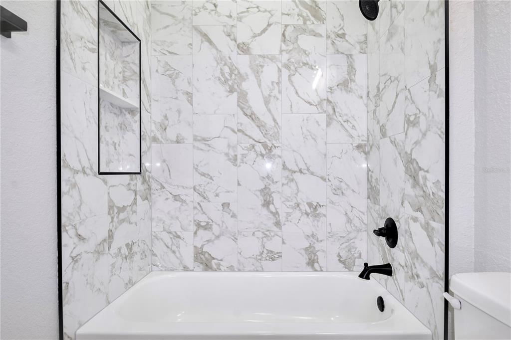 7335 Domenico Street Sebring, FL 33872 - Photo 30 of 38 a bathroom with a bathtub