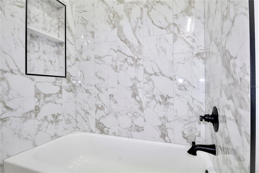 7335 Domenico Street Sebring, FL 33872 - Photo 31 of 38 a bathroom with a bathtub