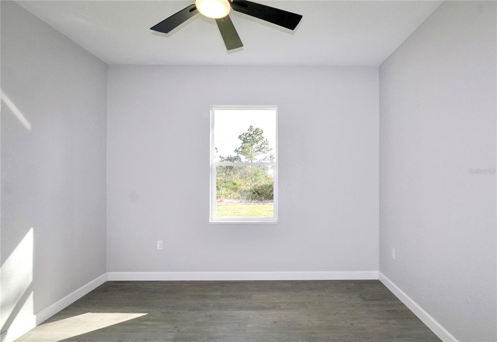 7335 Domenico Street Sebring, FL 33872 - Photo 32 of 38 an empty room with a window and a ceiling fan