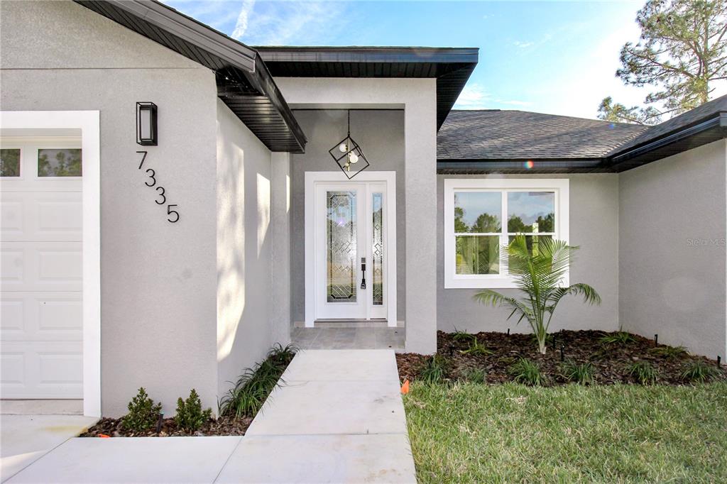 7335 Domenico Street Sebring, FL 33872 - Photo 8 of 38 a front view of a house with a yard
