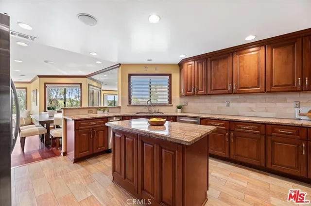 a kitchen with stainless steel appliances granite countertop a sink stove and cabinets