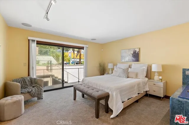 a bedroom with a bed and a couch