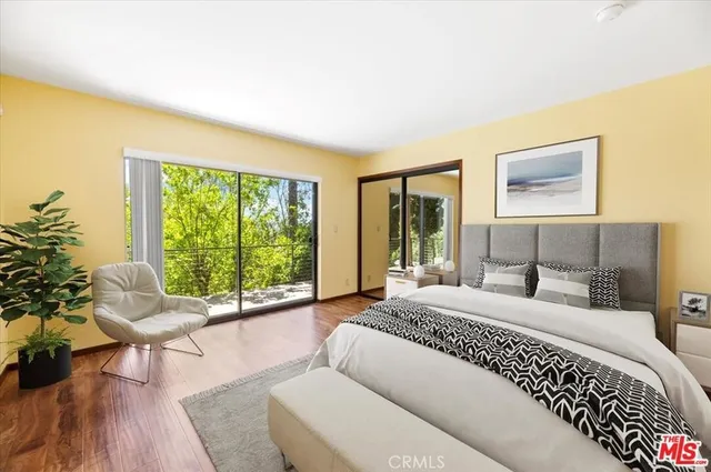 a living room with a large window and a wooden floor