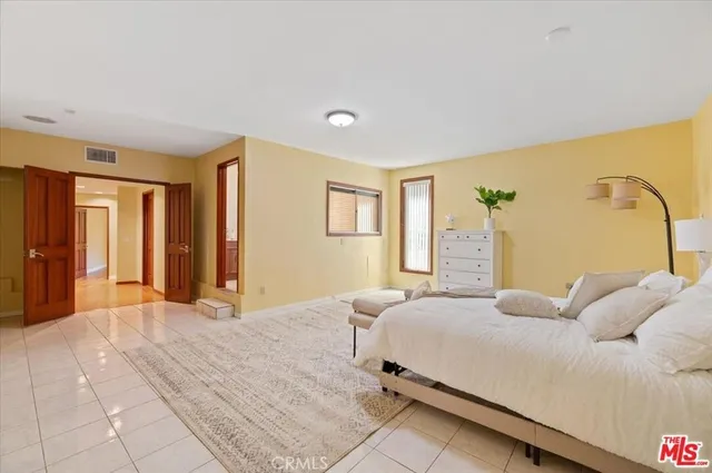 a bedroom with a large bed and a couch