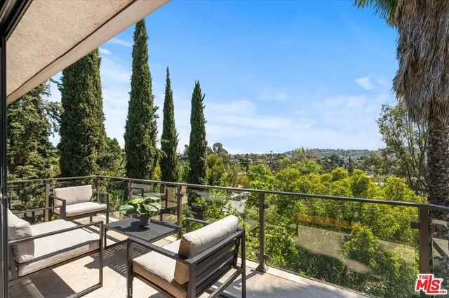 a view of a balcony with chairs