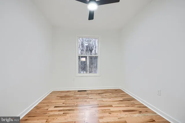 an empty room with wooden floor