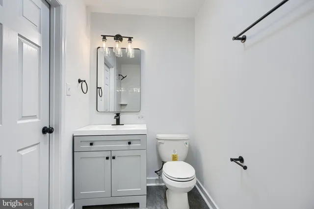 a bathroom with a sink toilet and mirror