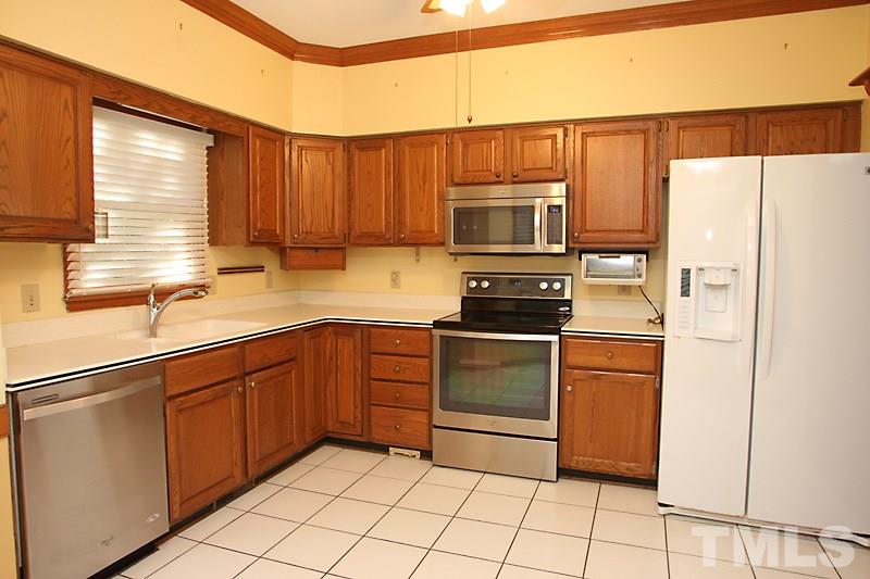 7811 Coach House Lane Raleigh, NC 27615 - Photo 3 of 19 a kitchen with stainless steel appliances a refrigerator sink and microwave