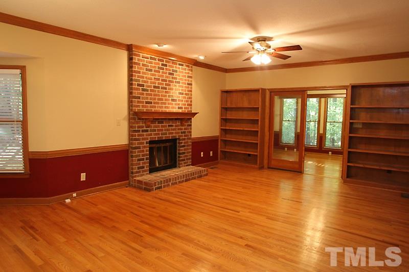 7811 Coach House Lane Raleigh, NC 27615 - Photo 5 of 19 a view of livingroom with furniture chandelier fan and fire place