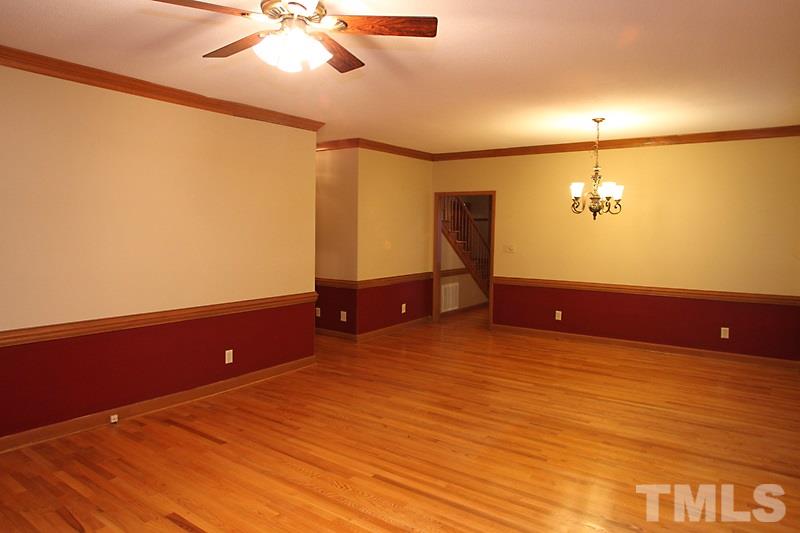 7811 Coach House Lane Raleigh, NC 27615 - Photo 7 of 19 a view of a room with cabinet a ceiling fan and wooden floor