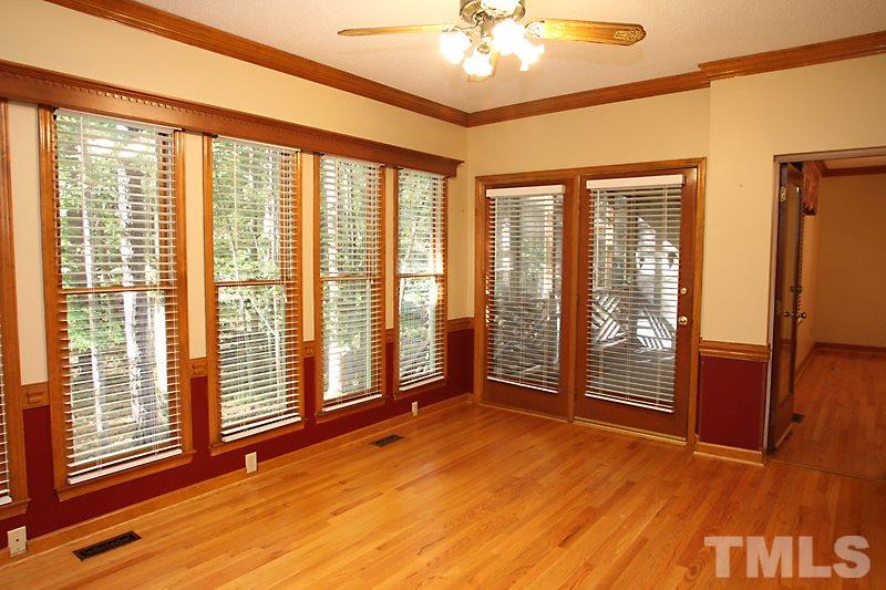 7811 Coach House Lane Raleigh, NC 27615 - Photo 8 of 19 a view of an empty room with a window and wooden floor