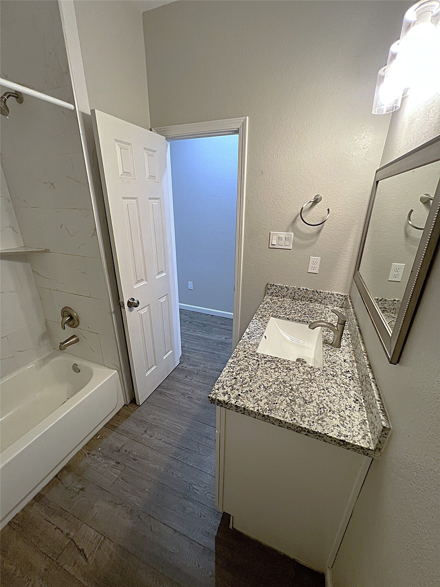 5779 Belarbor Street, Unit A Houston, TX 77033 - Photo 12 of 27 a bathroom with a granite countertop sink a toilet and bathtub