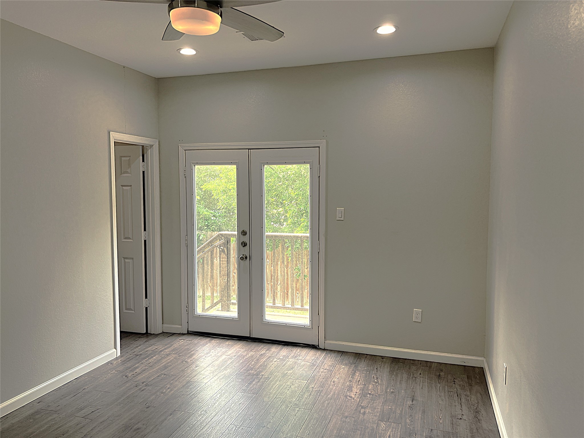 5779 Belarbor Street, Unit A Houston, TX 77033 - Photo 20 of 27 an empty room with wooden floor and windows