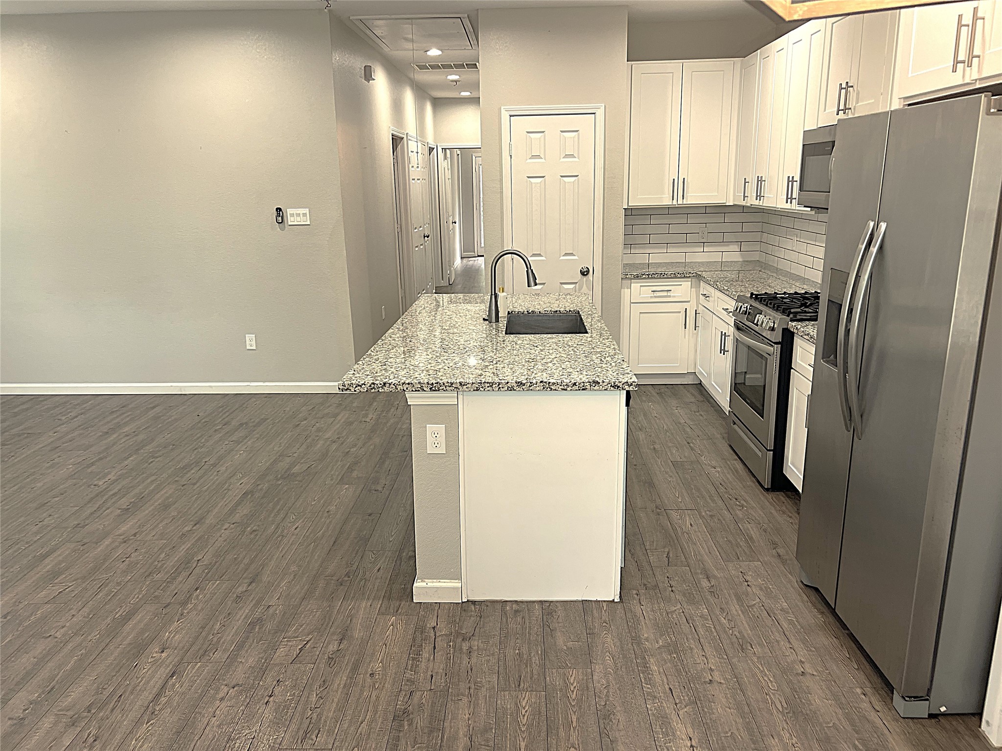 5779 Belarbor Street, Unit A Houston, TX 77033 - Photo 4 of 27 a kitchen with stainless steel appliances granite countertop a refrigerator a sink and dishwasher