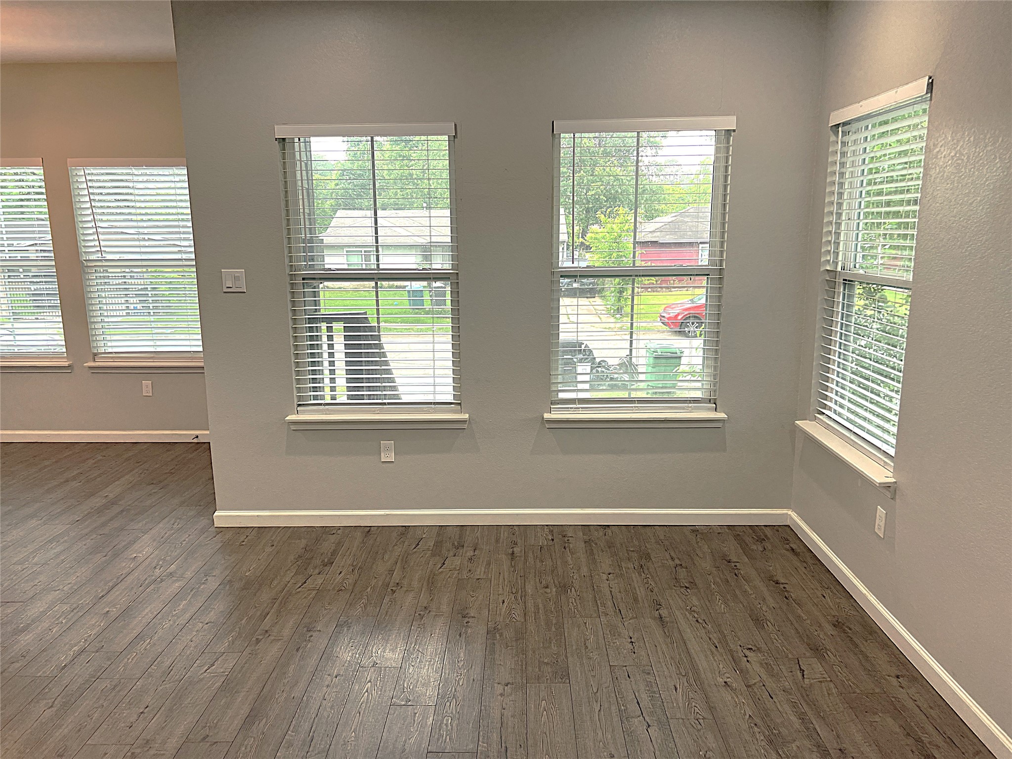 5779 Belarbor Street, Unit A Houston, TX 77033 - Photo 7 of 27 a view of an empty room with wooden floor and a window