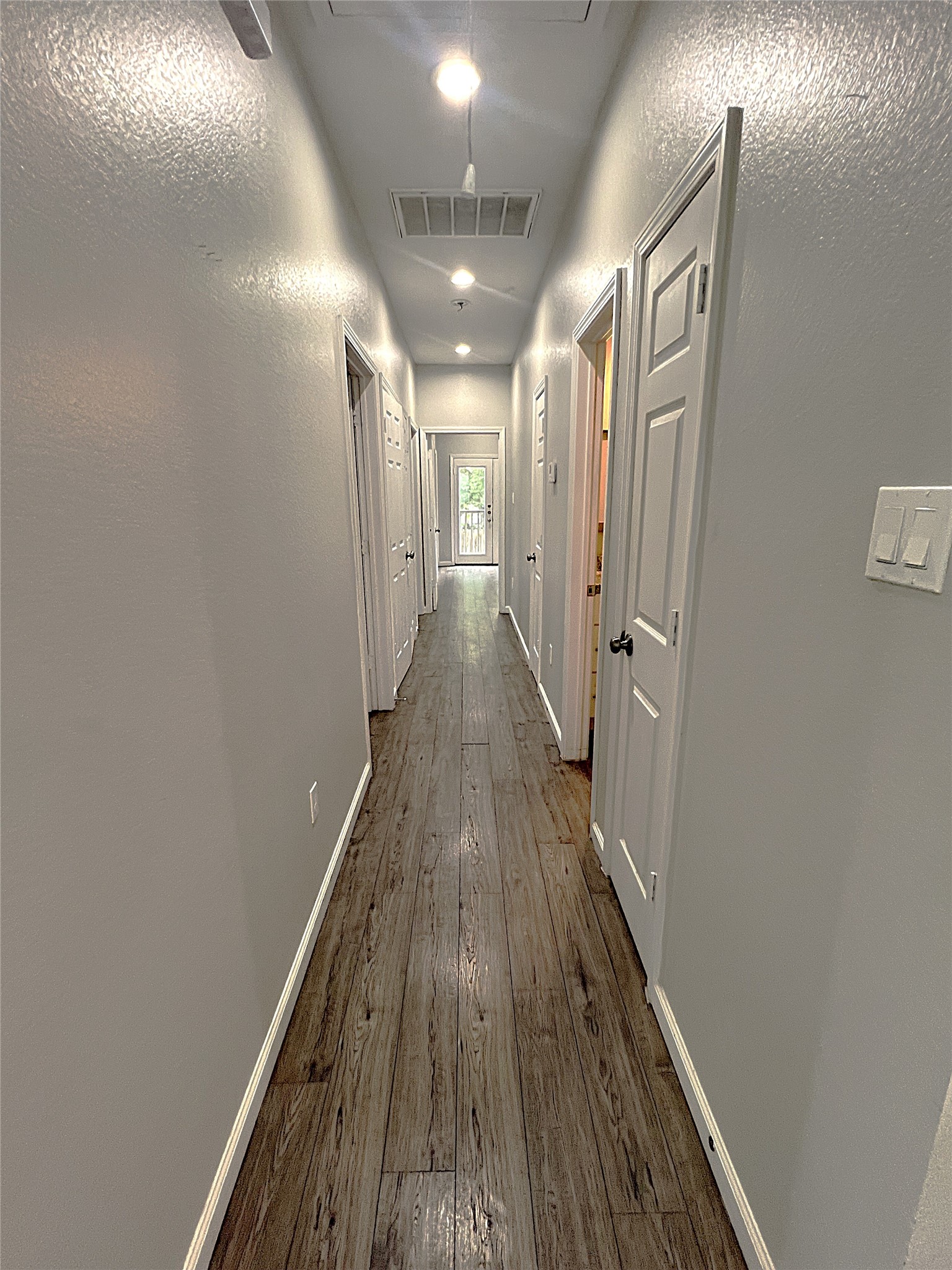 5779 Belarbor Street, Unit A Houston, TX 77033 - Photo 10 of 27 a view of a hallway with wooden floor