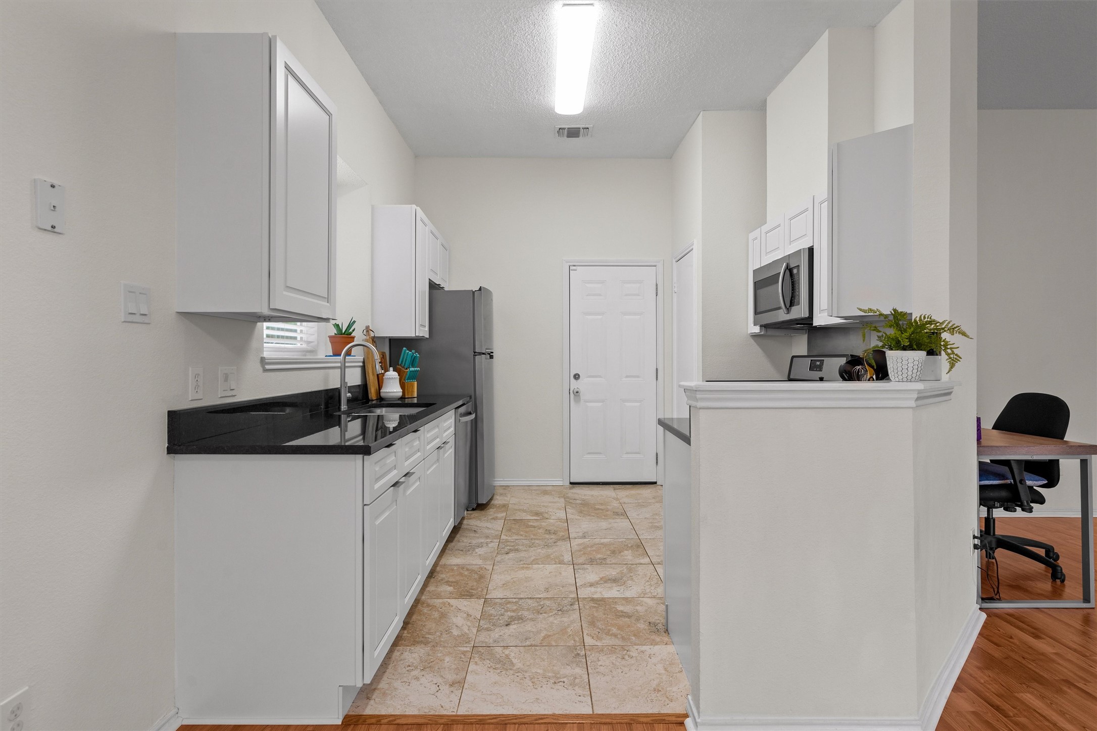 14818 Yellowleaf Trail Austin, TX 78728 - Photo 11 of 40 a kitchen with granite countertop a sink and a stove top oven