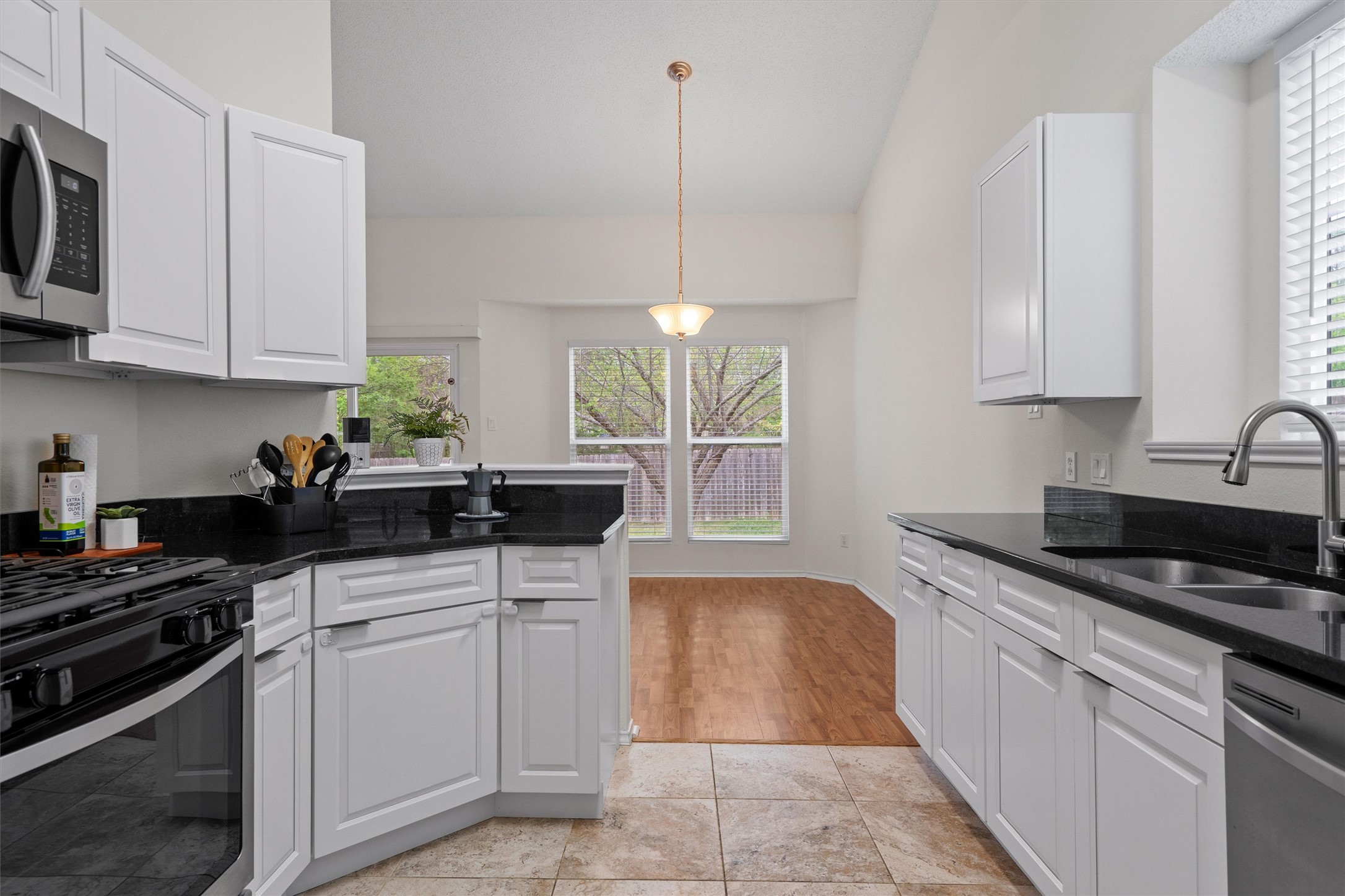 14818 Yellowleaf Trail Austin, TX 78728 - Photo 12 of 40 a kitchen with stainless steel appliances granite countertop a sink stove and cabinets