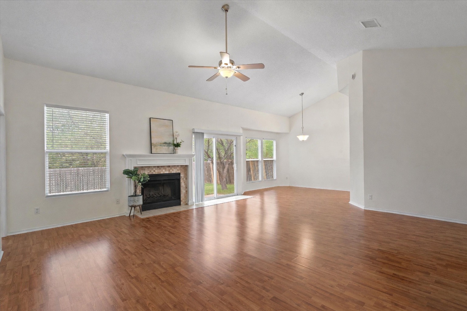 14818 Yellowleaf Trail Austin, TX 78728 - Photo 3 of 40 a view of an empty room with wooden floor fireplace and a window