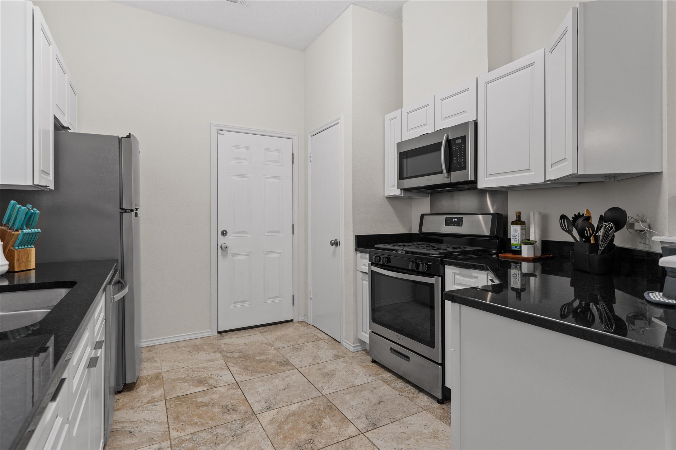 14818 Yellowleaf Trail Austin, TX 78728 - Photo 4 of 40 a kitchen with stainless steel appliances granite countertop a stove a sink and a refrigerator