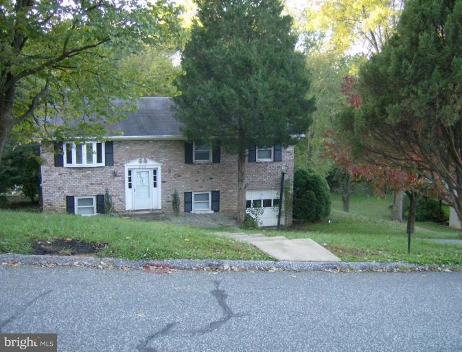 2108 Round Hill Road Fallston, MD 21047 - Photo 1 of 1 a front view of a house with a garden and trees